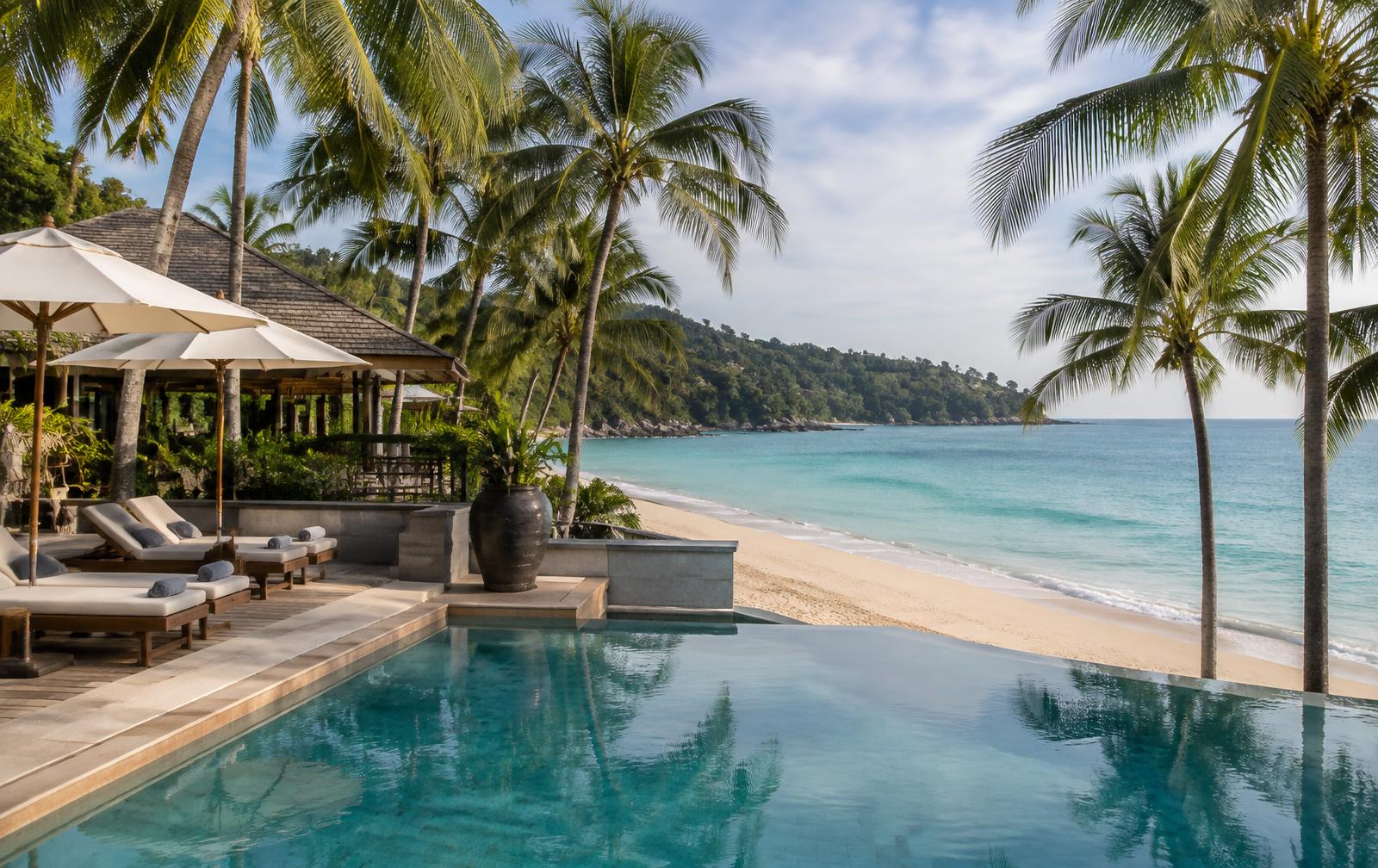 Resort pool terrace overlooking a quiet Phuket beach